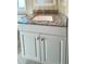Close-up of a white vanity with granite countertops and brushed nickel hardware in the bathroom at 3232 Ash Ter, Sarasota, FL 34237