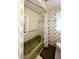 Bathroom features a shower-tub combo with floral wallpaper and grab bars for accessibility at 3232 Ash Ter, Sarasota, FL 34237