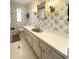 Full bathroom featuring an extended white vanity, green colored sink, and patterned wallpaper design at 3232 Ash Ter, Sarasota, FL 34237