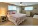 Bright bedroom featuring ceiling fan and two large windows at 3232 Ash Ter, Sarasota, FL 34237