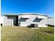 Side view of the home featuring tidy landscaping, an AC unit, and sun shades over the windows at 3232 Ash Ter, Sarasota, FL 34237
