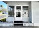 Inviting front entrance with a glass storm door and decorative rock accents at 3232 Ash Ter, Sarasota, FL 34237