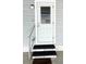 Charming front door with a storm door and steps leading to the entrance of the home at 3232 Ash Ter, Sarasota, FL 34237