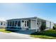 Charming single-story home featuring a screened-in porch and attached carport in a well-maintained community at 3232 Ash Ter, Sarasota, FL 34237