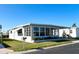 Charming single-story home featuring a screened-in porch and attached carport in a well-maintained community at 3232 Ash Ter, Sarasota, FL 34237