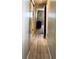 Hallway with wood-look laminate flooring and closet space at 3232 Ash Ter, Sarasota, FL 34237