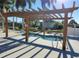 Hot tub with a wooden pergola providing shade at 3232 Ash Ter, Sarasota, FL 34237