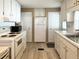 Bright eat-in kitchen featuring white appliances and laminate flooring at 3232 Ash Ter, Sarasota, FL 34237