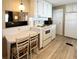 Eat-in kitchen has matching white appliances and adjacent breakfast area at 3232 Ash Ter, Sarasota, FL 34237
