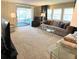 Cozy living room featuring neutral carpet, lots of seating, and ample natural light at 3232 Ash Ter, Sarasota, FL 34237