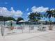 Community swimming pool area featuring lounge chairs and umbrellas on a sunny day at 3232 Ash Ter, Sarasota, FL 34237