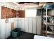 Functional storage room featuring a pegboard, shelving, storage containers and a window for natural light at 3232 Ash Ter, Sarasota, FL 34237