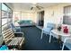 Inviting sunroom with casual seating, fan, and natural light through the numerous windows at 3232 Ash Ter, Sarasota, FL 34237