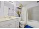 Cozy bathroom featuring a tub with shower, white vanity, and decorative floral accents at 3503 67Th W St, Bradenton, FL 34209