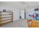 Bright bedroom with a ceiling fan, a wooden shelf, and an open doorway at 3503 67Th W St, Bradenton, FL 34209
