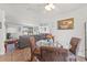 Dining area with a glass table and comfortable seating, adjacent to the living area at 3503 67Th W St, Bradenton, FL 34209