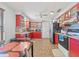 Efficient kitchen featuring bright red cabinetry, tile backsplash, and modern appliances at 3503 67Th W St, Bradenton, FL 34209