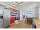 Kitchen and eating area showcasing stainless steel refrigerator, red cabinets, and tile flooring at 3503 67Th W St, Bradenton, FL 34209