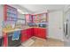 Functional kitchen with bold red cabinets, tile backsplash, and all essential appliances at 3503 67Th W St, Bradenton, FL 34209