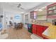 Eat-in kitchen area featuring red cabinets and stainless steel sink, adjacent to a charming dining space at 3503 67Th W St, Bradenton, FL 34209