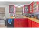 Cozy kitchen featuring red cabinetry, wooden countertops, and stainless steel sink beneath a bright window at 3503 67Th W St, Bradenton, FL 34209