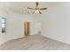 Spacious living room with light grey wood-look floors, ceiling fan and multiple entryways to the other rooms at 357 Woodvale Dr, Venice, FL 34293