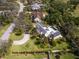 Aerial view of the house with a pool and solar panels on the roof amid lush landscaping at 3648 Beneva Oaks Blvd, Sarasota, FL 34238