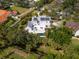 Aerial view featuring a home with a backyard pool, deck, lush greenery, and solar panels at 3648 Beneva Oaks Blvd, Sarasota, FL 34238