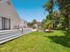Lush backyard with a pool, spacious deck, and mature trees, perfect for outdoor living at 3648 Beneva Oaks Blvd, Sarasota, FL 34238