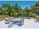 Relax on the wooden deck with comfortable seating overlooking the pristine pool and lush landscaping at 3648 Beneva Oaks Blvd, Sarasota, FL 34238