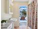 Bright bathroom with a pedestal sink and an open doorway with a deck view at 3648 Beneva Oaks Blvd, Sarasota, FL 34238