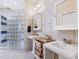 Well-lit bathroom with dual sinks, stylish cabinets, and a glass block shower at 3648 Beneva Oaks Blvd, Sarasota, FL 34238