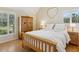 Cozy bedroom with warm wood accents, a large wardrobe, and natural light from the windows at 3648 Beneva Oaks Blvd, Sarasota, FL 34238