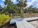 Outdoor deck area surrounded by lush greenery and mature trees with a tranquil view at 3648 Beneva Oaks Blvd, Sarasota, FL 34238