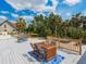 Large wooden deck with dining table and chairs overlooking the serene backyard at 3648 Beneva Oaks Blvd, Sarasota, FL 34238