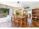 Dining area with wooden table and chairs, terracotta tile flooring, and outdoor access at 3648 Beneva Oaks Blvd, Sarasota, FL 34238