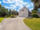 Inviting home featuring a spacious driveway leading to a two-car garage and a charming wooden deck area at 3648 Beneva Oaks Blvd, Sarasota, FL 34238
