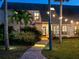 Inviting home entrance with a brick pathway enhanced by subtle landscape lighting at 3648 Beneva Oaks Blvd, Sarasota, FL 34238