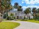 Spacious home features lush landscaping with mature palm trees and a curved driveway at 3648 Beneva Oaks Blvd, Sarasota, FL 34238