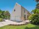 Home's exterior boasts two-car garage, lush landscaping, brick patio, and driveway at 3648 Beneva Oaks Blvd, Sarasota, FL 34238