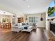 Spacious living room featuring hardwood floors, comfortable seating, and a view into dining room at 3648 Beneva Oaks Blvd, Sarasota, FL 34238