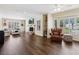Spacious living room with hardwood floors, fireplace, stylish furniture, and ample natural light at 3648 Beneva Oaks Blvd, Sarasota, FL 34238