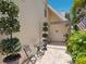Cozy outdoor patio with brick pavers, seating, potted plants, and privacy landscaping at 3648 Beneva Oaks Blvd, Sarasota, FL 34238
