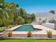 Inviting backyard pool area surrounded by lush tropical landscaping and a spacious deck at 3648 Beneva Oaks Blvd, Sarasota, FL 34238