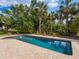 Beautiful swimming pool with a brick patio and lush landscaping at 3648 Beneva Oaks Blvd, Sarasota, FL 34238