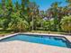 Enjoy a swim in this beautiful in-ground pool surrounded by lush greenery and a brick patio at 3648 Beneva Oaks Blvd, Sarasota, FL 34238