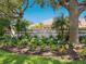 Landscaped signage at Beneva Oaks community featuring lush garden and mature trees at 3648 Beneva Oaks Blvd, Sarasota, FL 34238