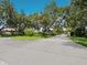 Scenic street view showcasing lush greenery and beautifully landscaped homes in a desirable neighborhood at 3648 Beneva Oaks Blvd, Sarasota, FL 34238