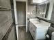 Modern bathroom featuring a white vanity, gray tile, framed mirror and updated fixtures at 3826 Clover Ln, Sarasota, FL 34233