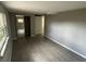 Bedroom featuring gray walls, wood-look tile flooring, and a mirrored closet at 3826 Clover Ln, Sarasota, FL 34233
